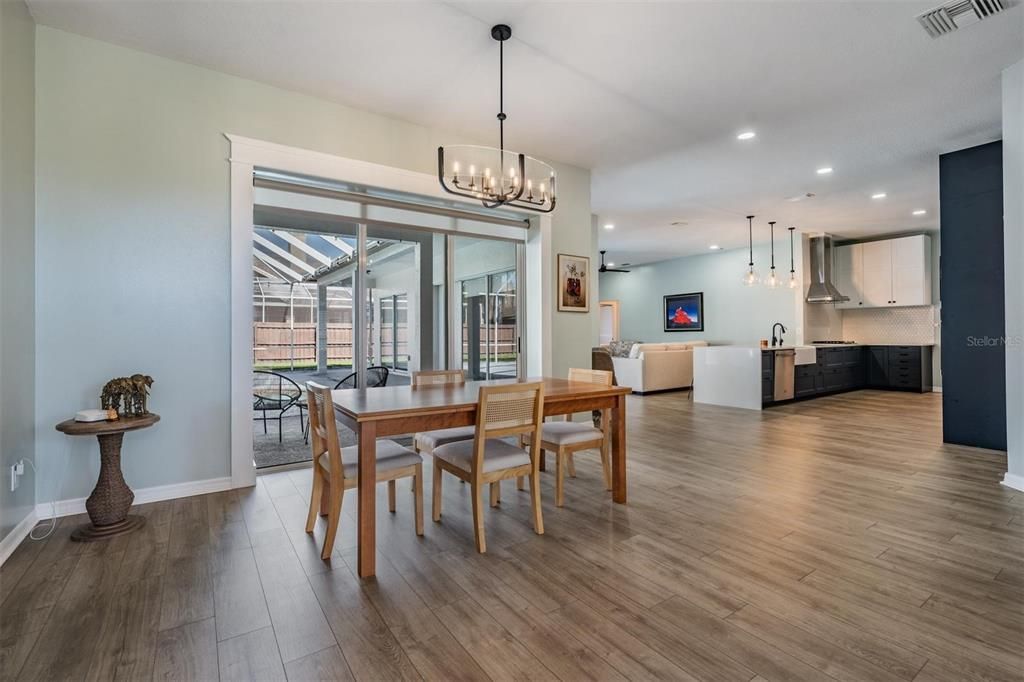 Chandelier, Dining room, Fireplace, Interior, Living room, Pendant Lights, Recessed Lighting, Wood Texture Flooring