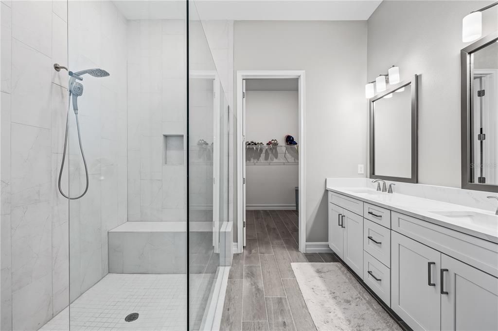 Bathroom, Dual Sink Vanities, Glass Shower, Interior, Marble Walls, Wood Texture Flooring