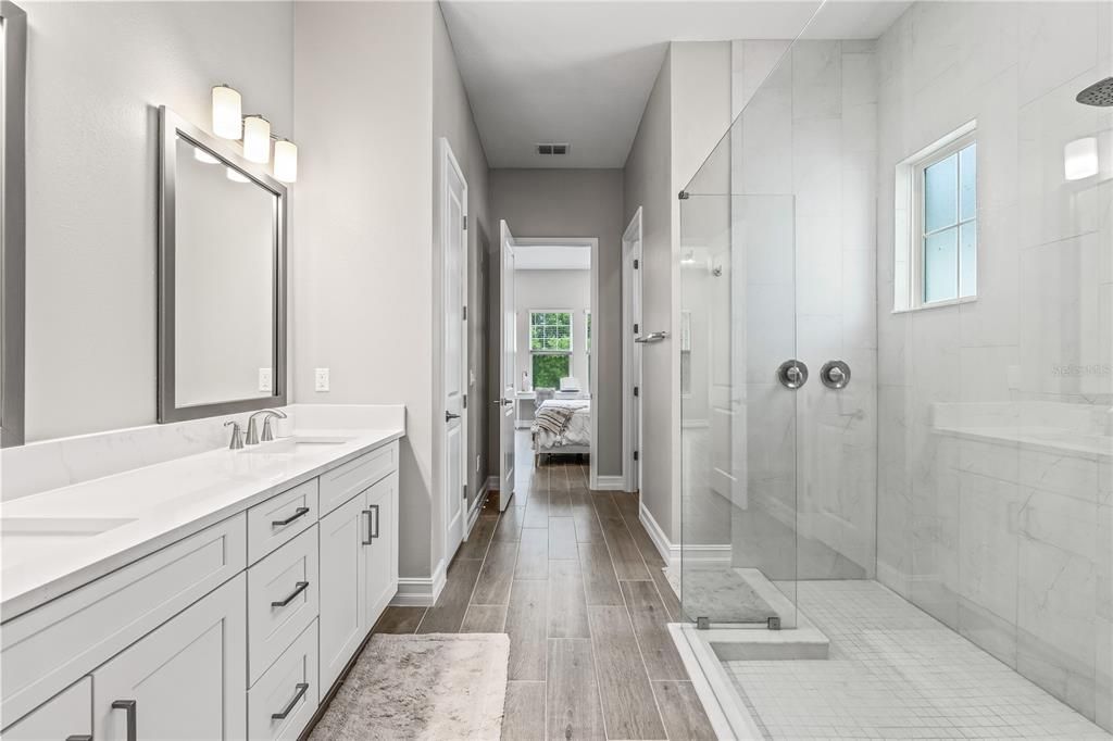 Bathroom, Dual Sink Vanities, Glass Shower, Interior, Marble Walls, Wood Texture Flooring