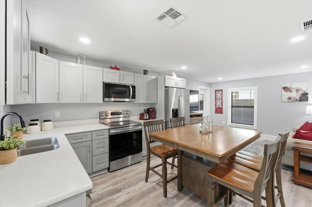 Dining room, Interior, Kitchen, Recessed Lighting, Stainless Steel Appliances, Wood Texture Flooring