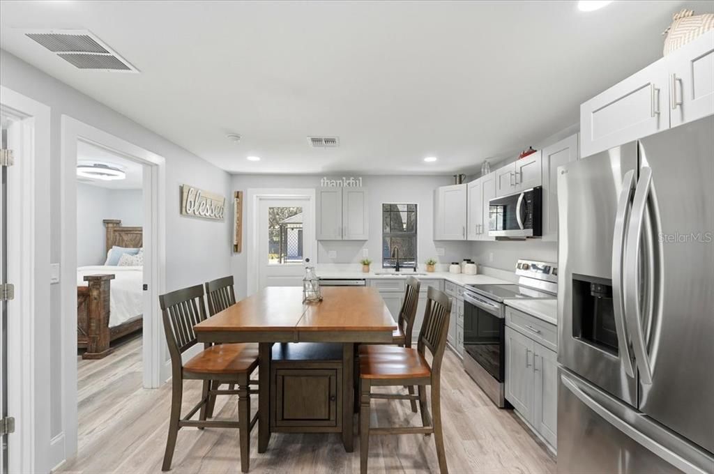 Bedroom, Dining room, Interior, Kitchen, Recessed Lighting, Stainless Steel Appliances, Wood Texture Flooring