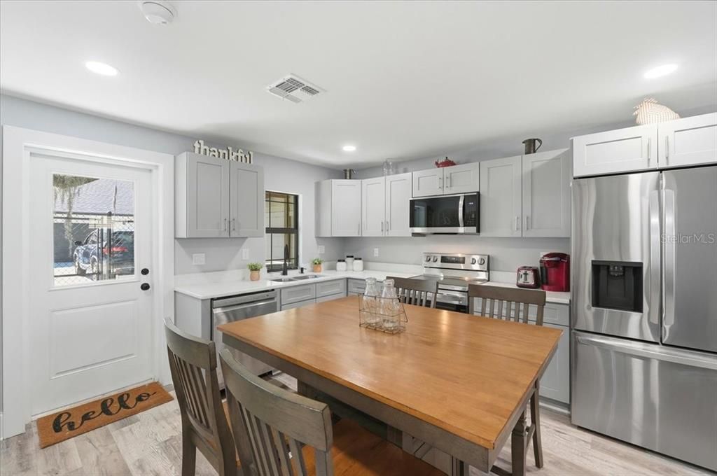 Dining room, Interior, Kitchen, Recessed Lighting, Stainless Steel Appliances, Wood Texture Flooring