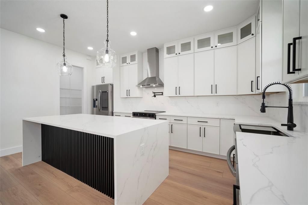 Interior, Kitchen, Marble Walls, Pendant Lights, Recessed Lighting, Stainless Steel Appliances, Wood Texture Flooring