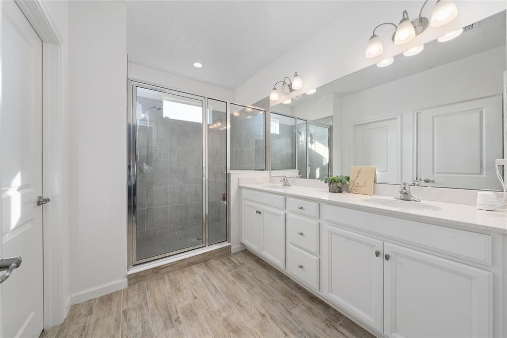 Bathroom, Dual Sink Vanities, Glass Shower, Interior, Recessed Lighting, Wood Texture Flooring