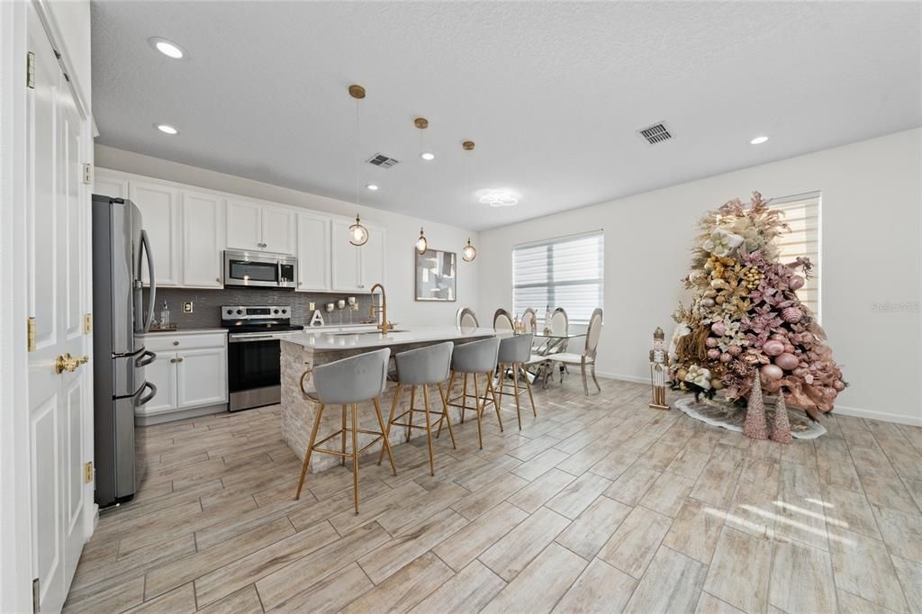 Dining room, Interior, Kitchen, Pendant Lights, Recessed Lighting, Stainless Steel Appliances, Wood Texture Flooring