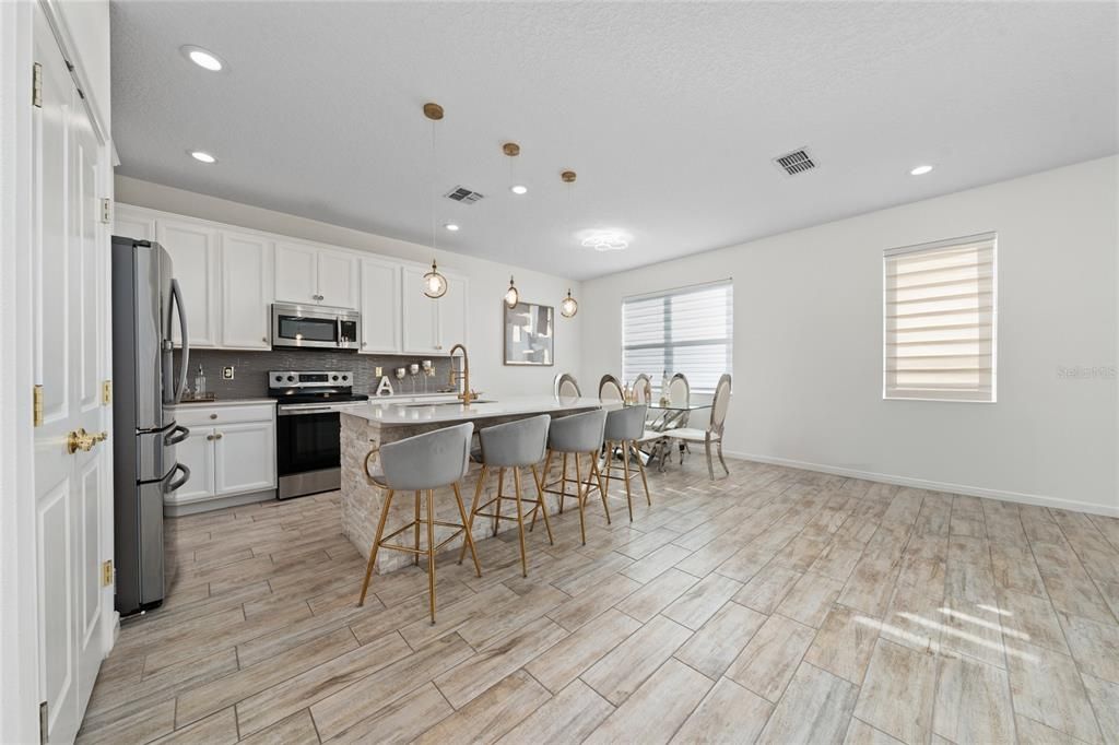Dining room, Interior, Kitchen, Pendant Lights, Recessed Lighting, Stainless Steel Appliances, Wood Texture Flooring