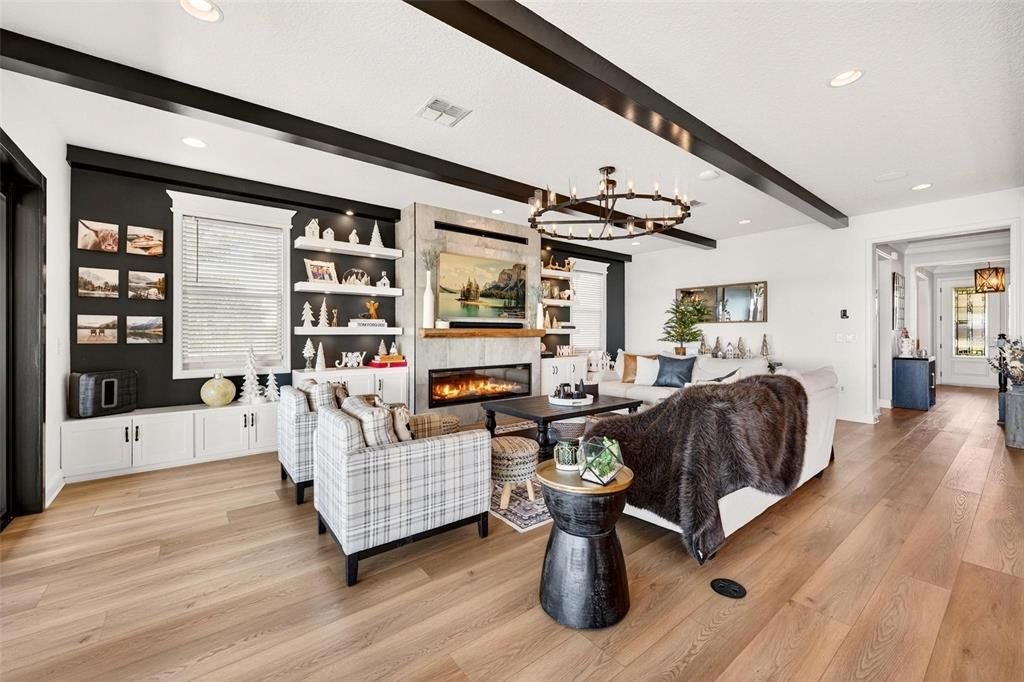 Chandelier, Fireplace, Interior, Living room, Pendant Lights, Recessed Lighting, Wooden Beams, Wood Texture Flooring