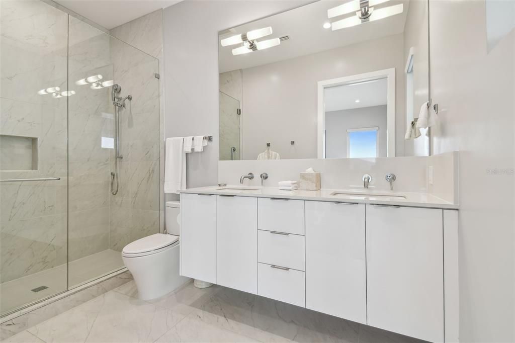 Bathroom, Dual Sink Vanities, Glass Shower, Interior, Marble, Marble Walls, Recessed Lighting