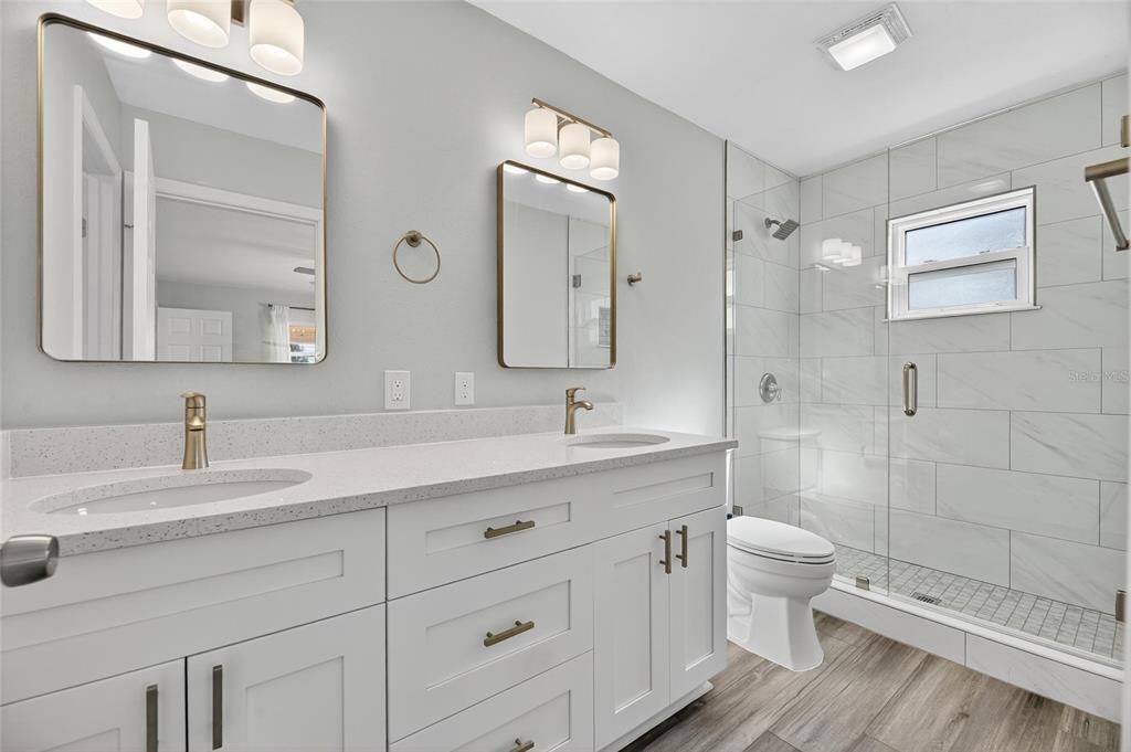 Bathroom, Dual Sink Vanities, Glass Shower, Interior, Marble Walls, Wood Texture Flooring
