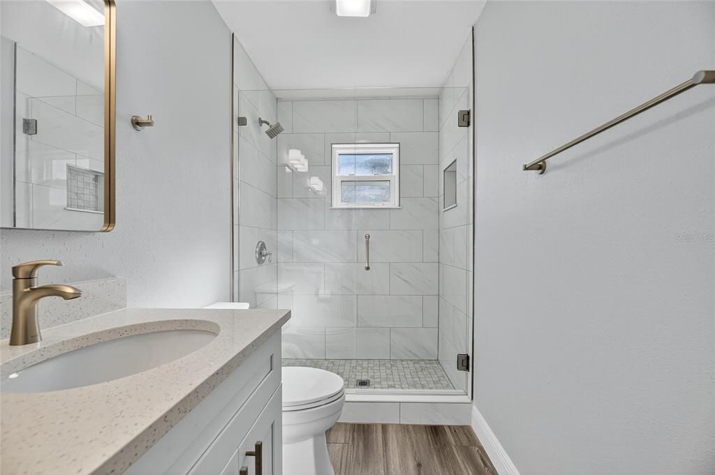 Bathroom, Glass Shower, Interior, Marble Walls, Wood Texture Flooring