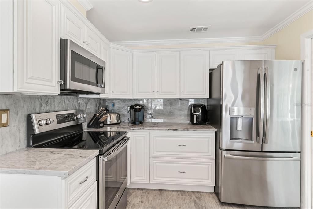 Interior, Kitchen, Recessed Lighting, Tile Countertops, Wood Texture Flooring