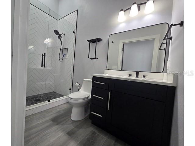 Bathroom, Dual Sink Vanities, Glass Shower, Interior, Marble Walls, Wood Texture Flooring