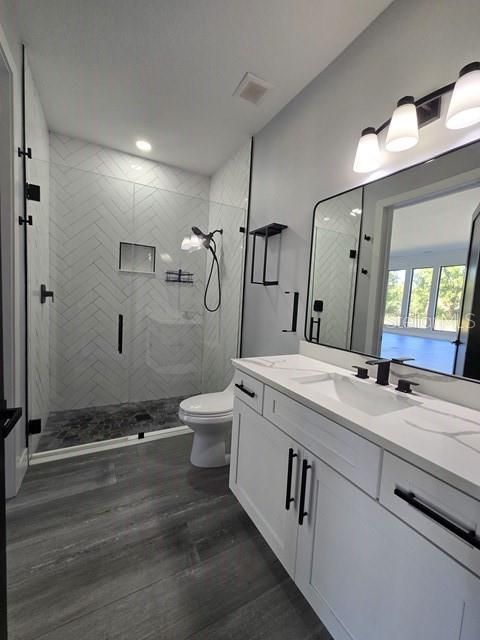 Bathroom, Dual Sink Vanities, Glass Shower, Interior, Marble Walls, Recessed Lighting, Wood Texture Flooring