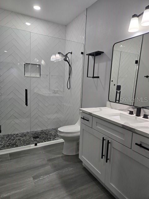 Bathroom, Dual Sink Vanities, Glass Shower, Interior, Marble Walls, Recessed Lighting, Wood Texture Flooring