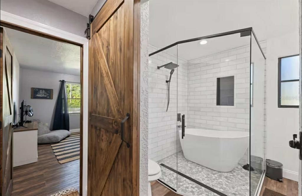 Bathroom, Free Standing Baths, Glass Shower, Interior, Recessed Lighting, Wood Texture Flooring