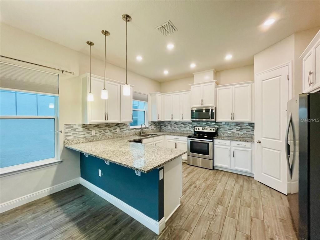 Interior, Kitchen, Pendant Lights, Recessed Lighting, Stainless Steel Appliances, Wood Texture Flooring