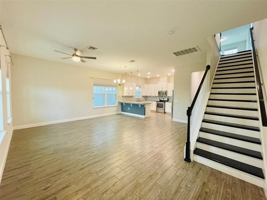 Empty room, Interior, Kitchen, Pendant Lights, Recessed Lighting, Stainless Steel Appliances, Wood Texture Flooring