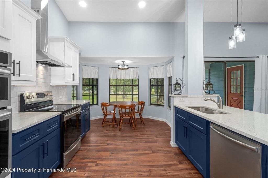 Dining room, Interior, Kitchen, Pendant Lights, Recessed Lighting, Stainless Steel Appliances, Wood Texture Flooring