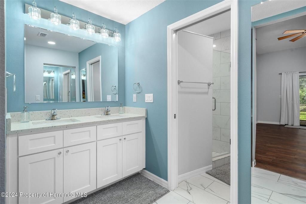 Bathroom, Dual Sink Vanities, Glass Shower, Interior, Marble, Marble Walls, Wood Texture Flooring