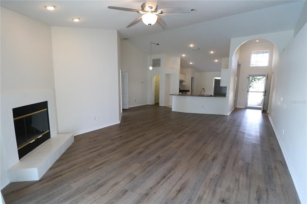 Empty room, Fireplace, Interior, Kitchen, Pendant Lights, Recessed Lighting, Wood Texture Flooring
