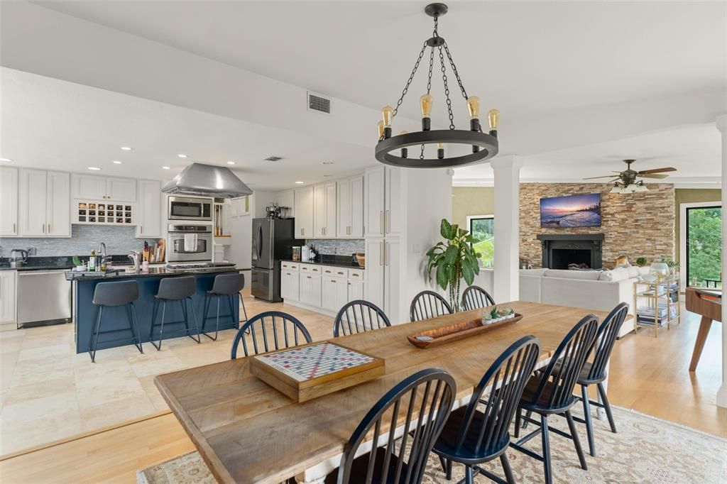 Dining room, Fireplace, Interior, Kitchen, Pendant Lights, Recessed Lighting, Stainless Steel Appliances, Stone Walls, Wood Texture Flooring