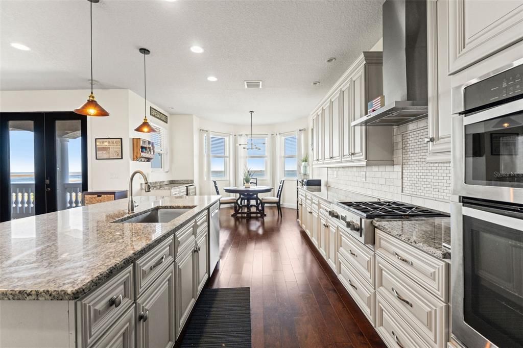 Dining room, Interior, Kitchen, Pendant Lights, Recessed Lighting, Stainless Steel Appliances, Water, Wood Texture Flooring