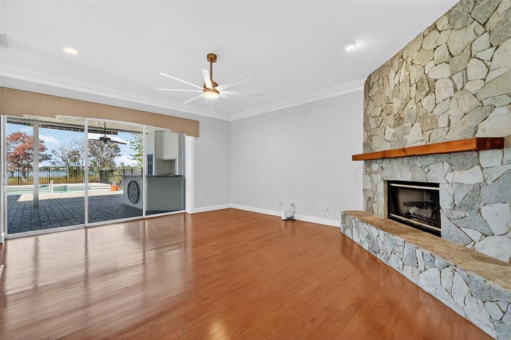 Empty room, Fireplace, Interior, Recessed Lighting, Stone Walls, Wood Texture Flooring