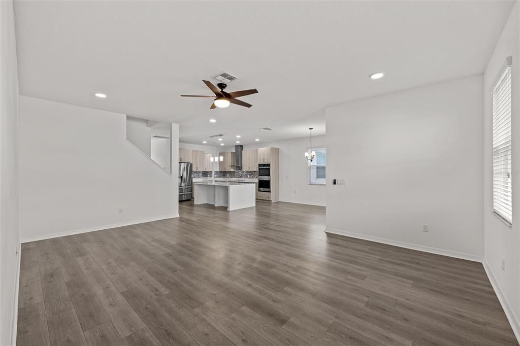 Empty room, Interior, Kitchen, Pendant Lights, Recessed Lighting, Stainless Steel Appliances, Wood Texture Flooring