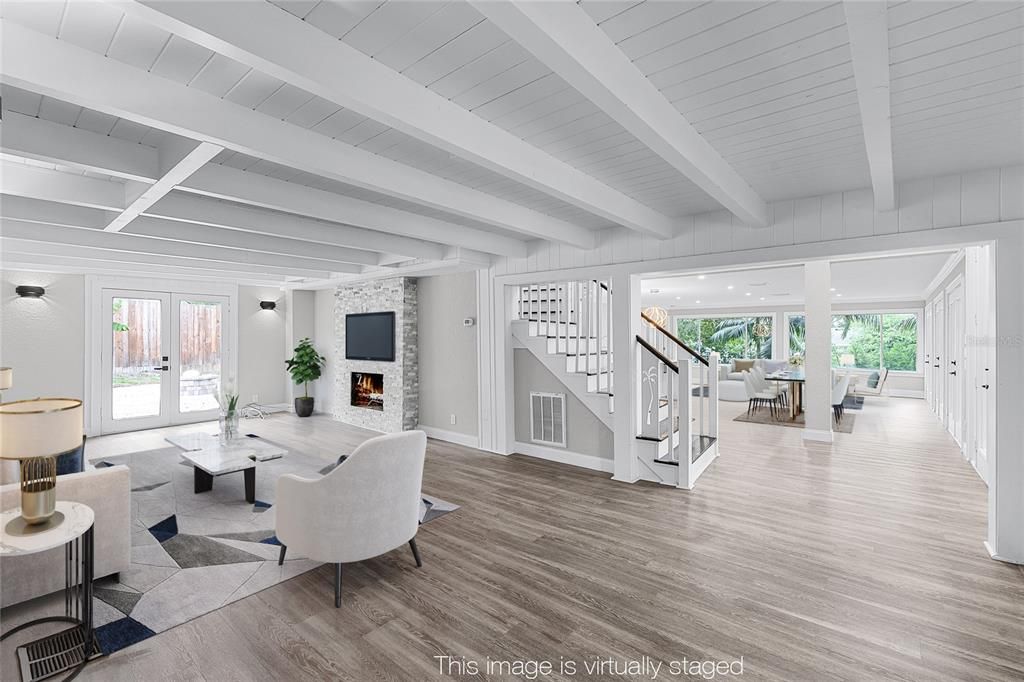 Dining room, Fireplace, Interior, Living room, Recessed Lighting, Stone Walls, Wood Texture Flooring