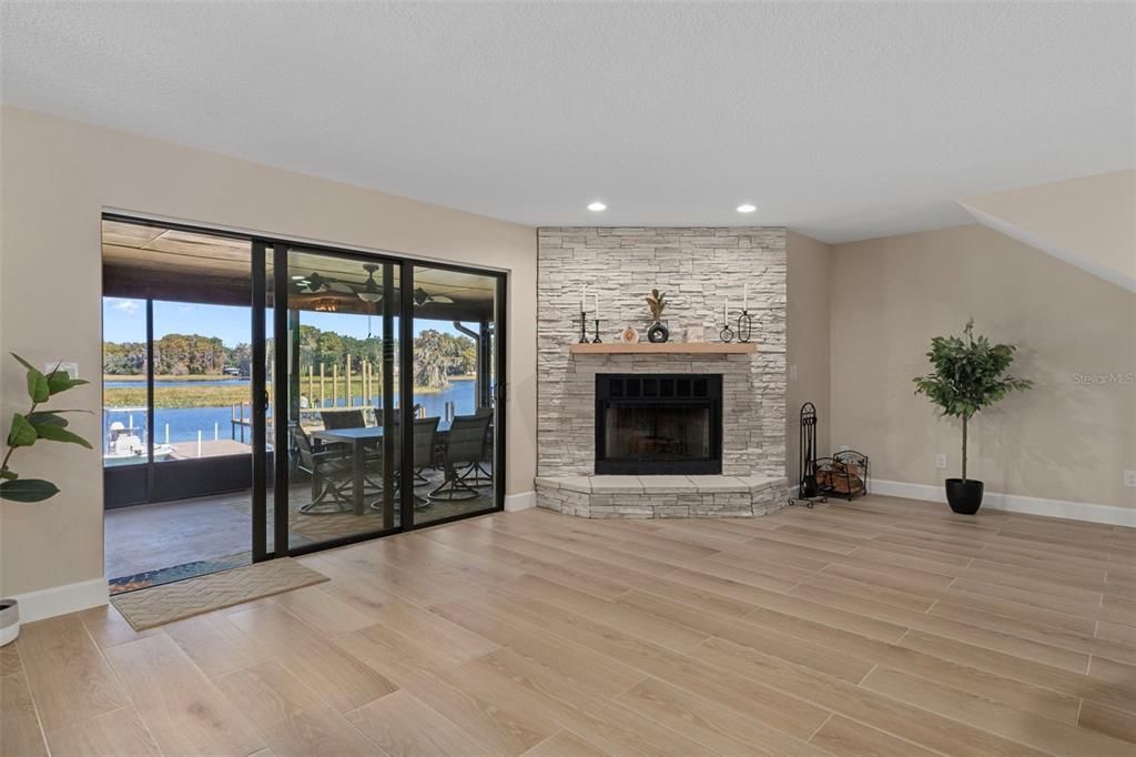 Fireplace, Interior, Recessed Lighting, Stone Walls, Water, Wood Texture Flooring