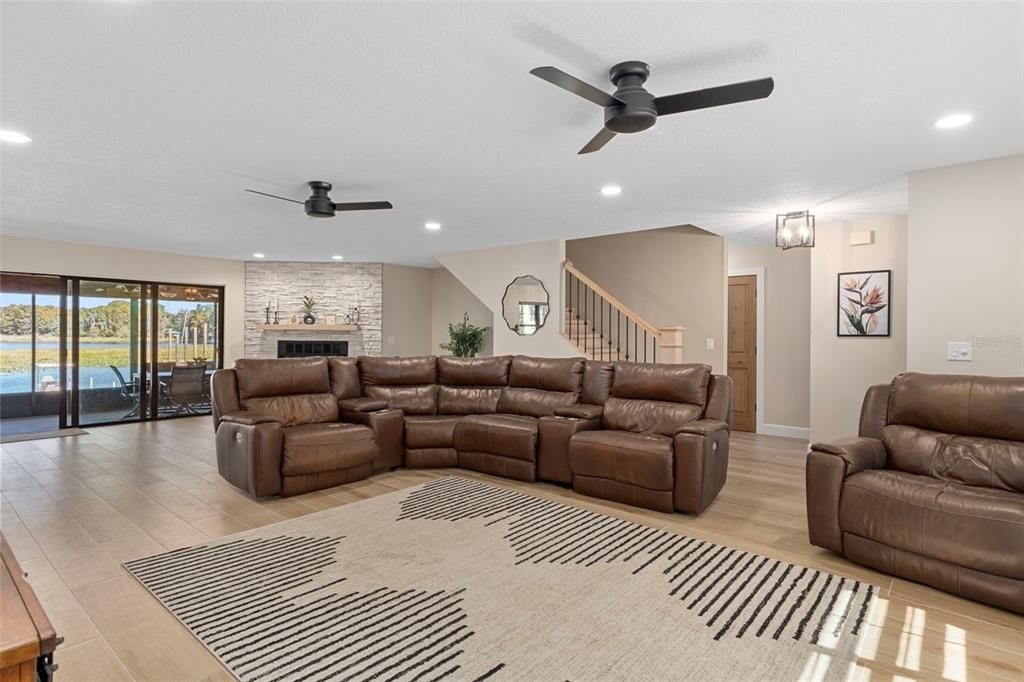 Fireplace, Interior, Living room, Recessed Lighting, Stone Walls, Wood Texture Flooring