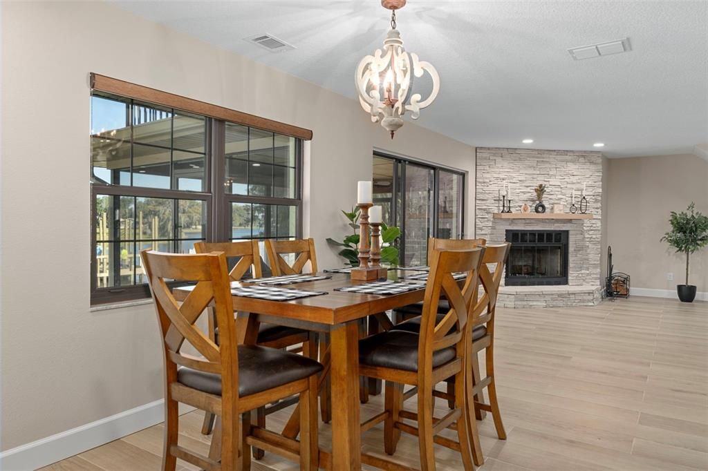 Chandelier, Dining room, Fireplace, Interior, Recessed Lighting, Stone Walls, Wood Texture Flooring
