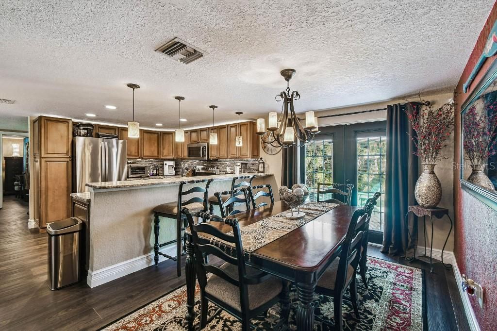 Chandelier, Dining room, Interior, Kitchen, Pendant Lights, Recessed Lighting, Stainless Steel Appliances, Wood Texture Flooring