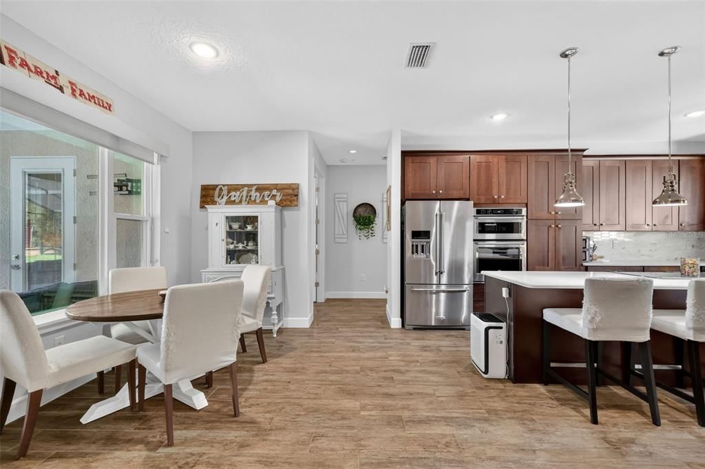 Dining room, Interior, Kitchen, Pendant Lights, Recessed Lighting, Stainless Steel Appliances, Wood Texture Flooring