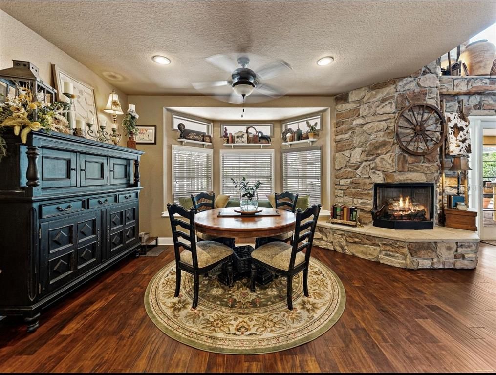 Dining room, Fireplace, Interior, Recessed Lighting, Stone Walls, Wood Texture Flooring