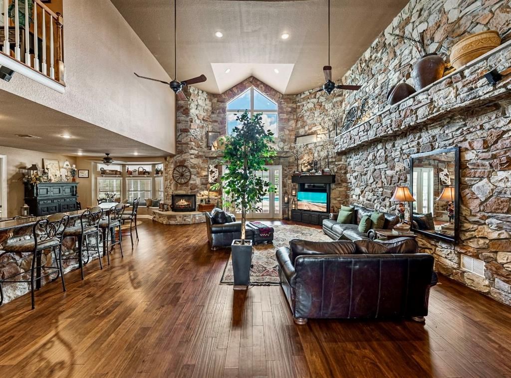 Dining room, Fireplace, Interior, Living room, Recessed Lighting, Stone Walls, Wood Texture Flooring