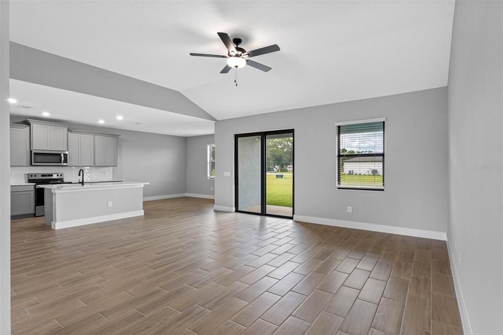 Empty room, Interior, Kitchen, Recessed Lighting, Stainless Steel Appliances, Wood Texture Flooring