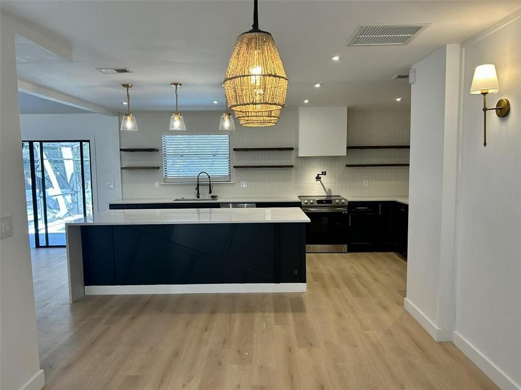 Chandelier, Interior, Kitchen, Pendant Lights, Recessed Lighting, Stainless Steel Appliances, Wood Texture Flooring
