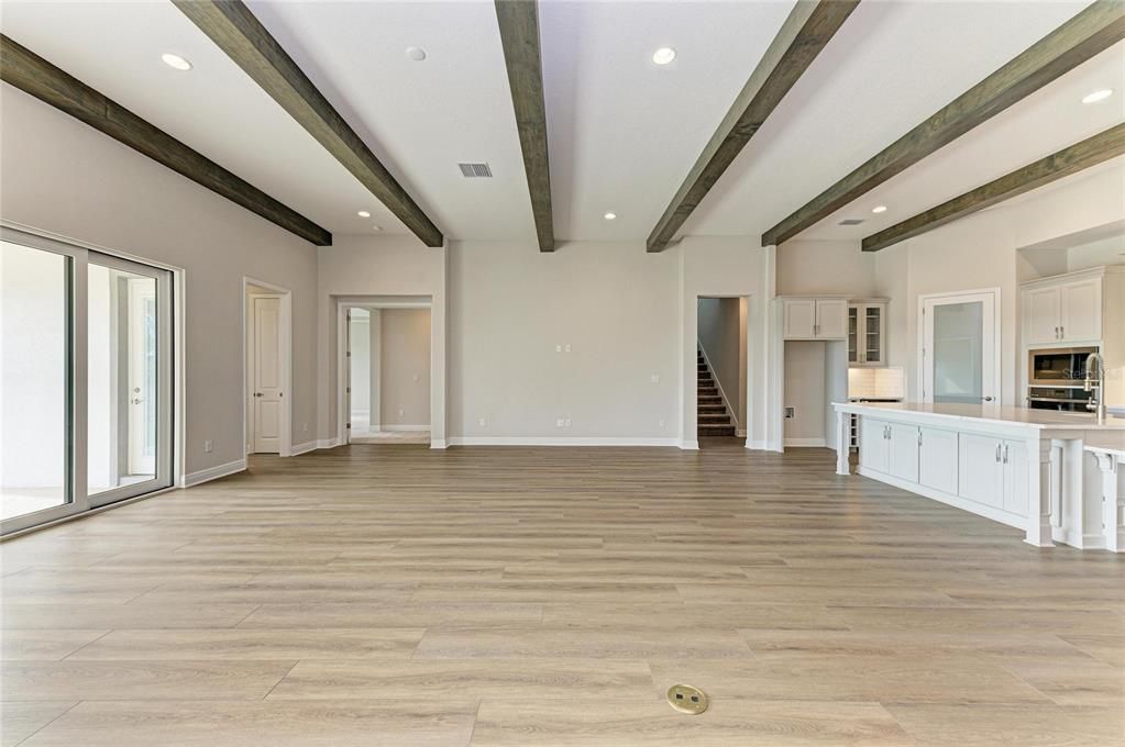 Empty room, Interior, Kitchen, Recessed Lighting, Stainless Steel Appliances, Wooden Beams, Wood Texture Flooring