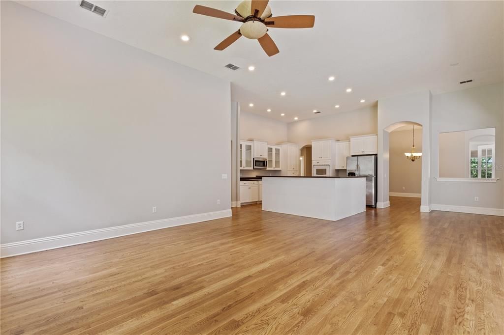 Empty room, Interior, Kitchen, Pendant Lights, Recessed Lighting, Stainless Steel Appliances, Wood Texture Flooring