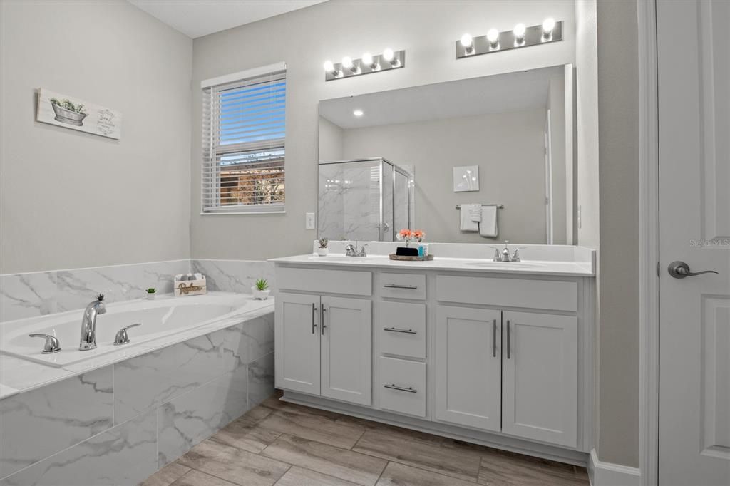 Bathroom, Dual Sink Vanities, Glass Shower, Interior, Marble Walls, Wood Texture Flooring