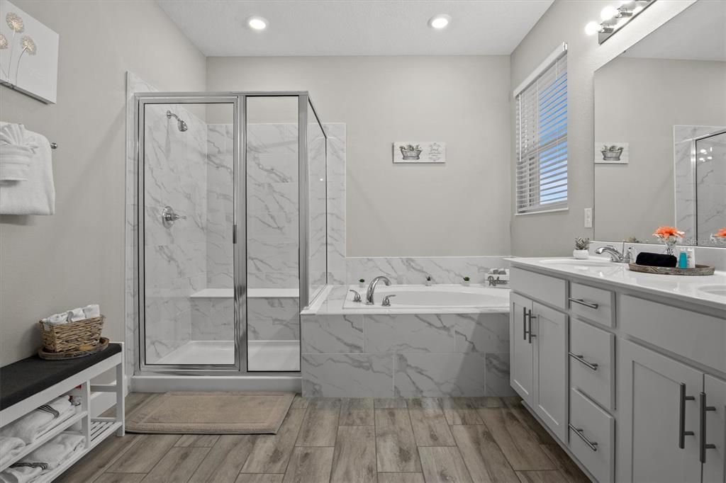 Bathroom, Dual Sink Vanities, Glass Shower, Interior, Marble Walls, Recessed Lighting, Wood Texture Flooring