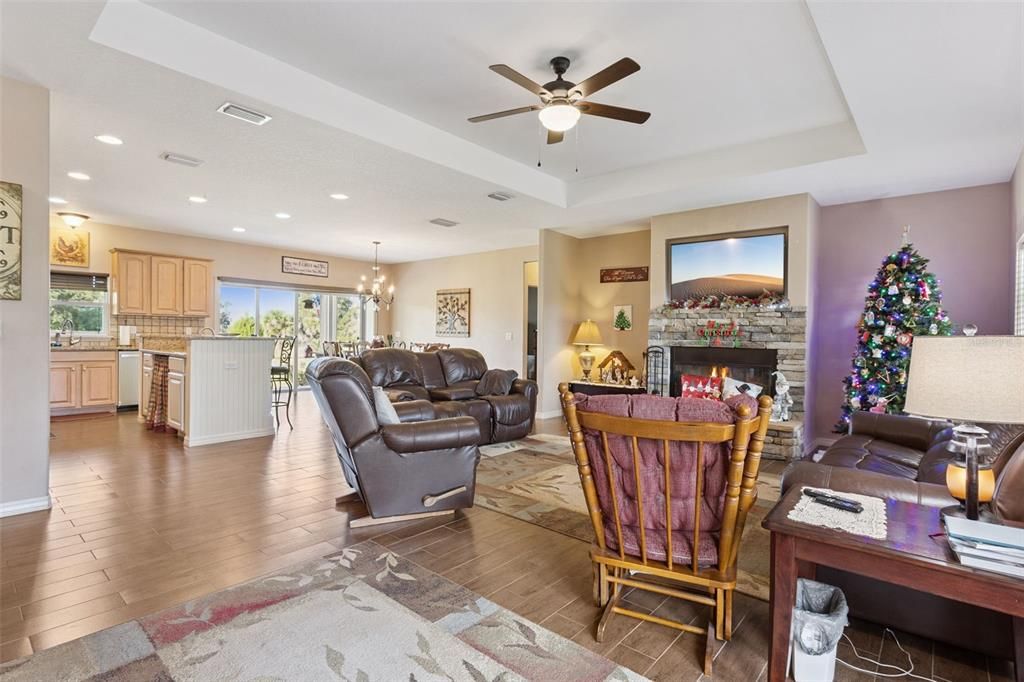 Chandelier, Fireplace, Interior, Kitchen, Living room, Recessed Lighting, Wood Texture Flooring