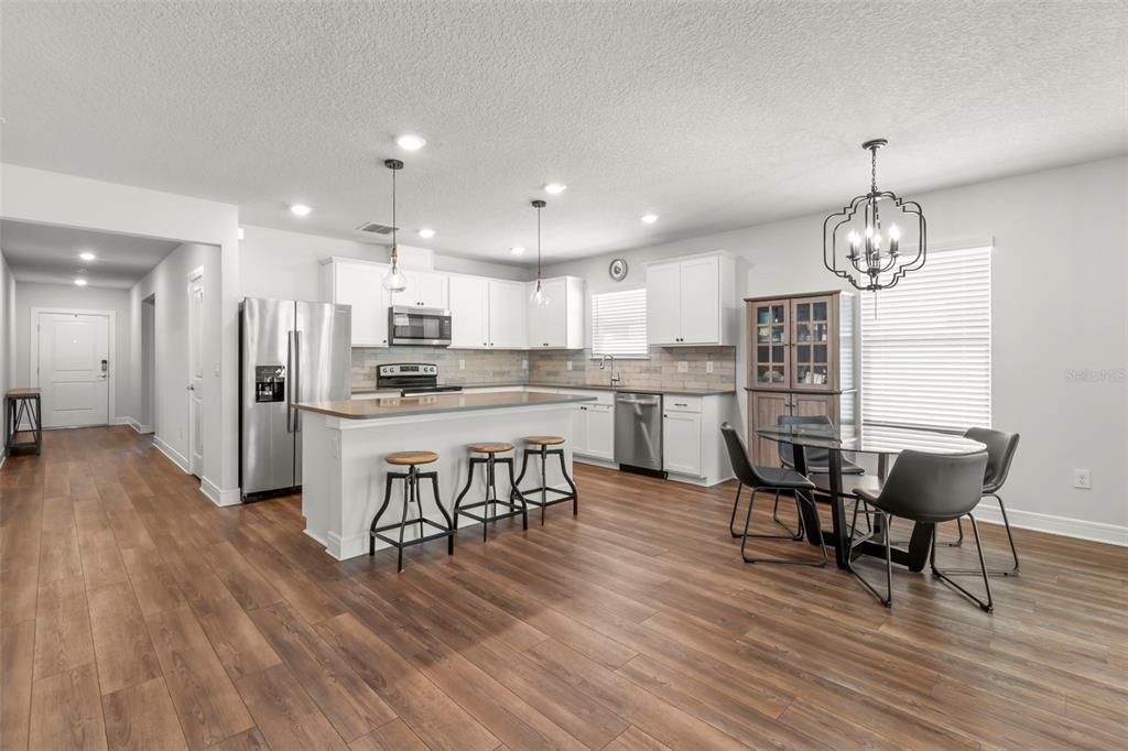 Dining room, Interior, Kitchen, Pendant Lights, Recessed Lighting, Stainless Steel Appliances, Wood Texture Flooring