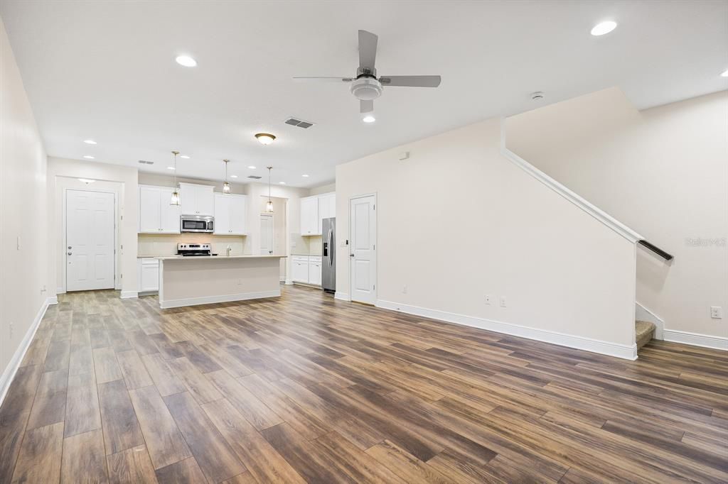 Empty room, Interior, Kitchen, Pendant Lights, Recessed Lighting, Stainless Steel Appliances, Wood Texture Flooring