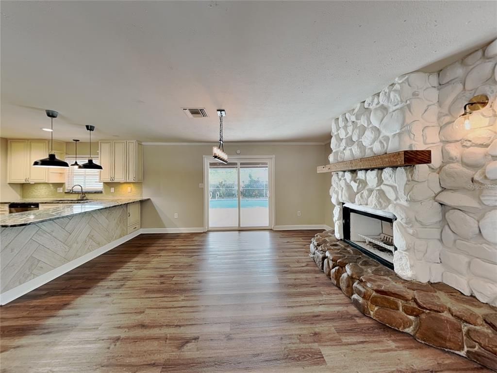 Empty room, Fireplace, Interior, Kitchen, Pendant Lights, Stone Walls, Wood Texture Flooring