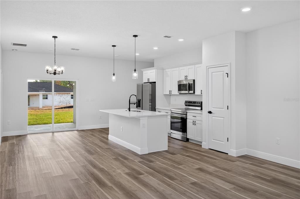 Chandelier, Interior, Kitchen, Pendant Lights, Recessed Lighting, Stainless Steel Appliances, Wood Texture Flooring