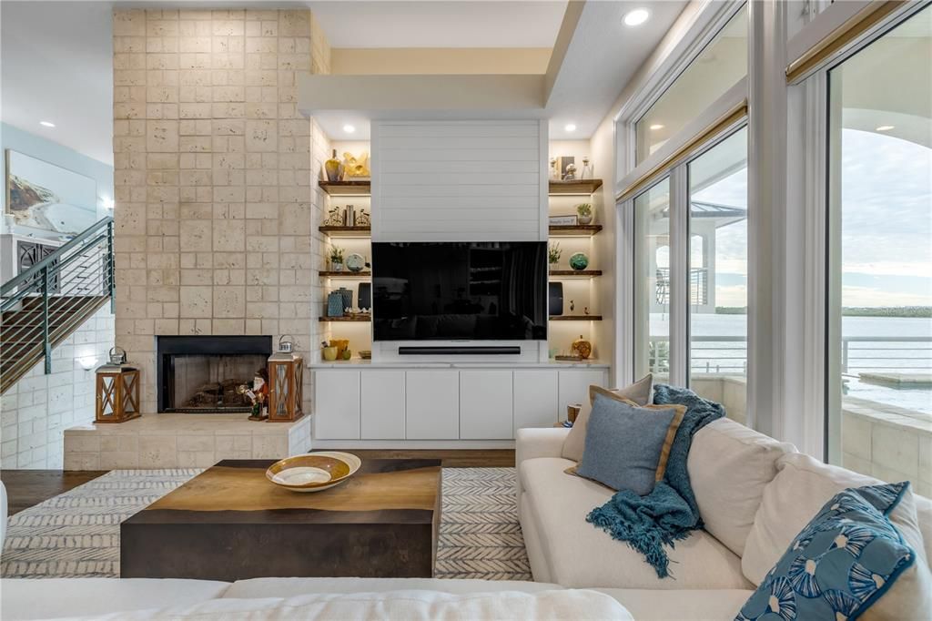 Fireplace, Interior, Living room, Recessed Lighting, Stone Walls, Water, Wood Texture Flooring