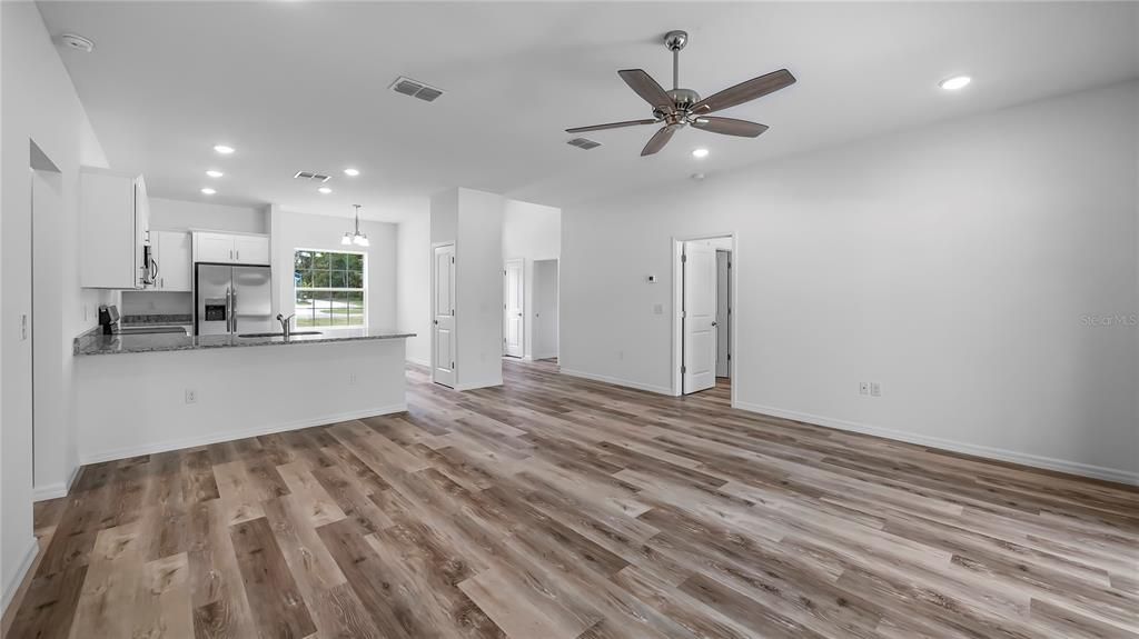 Empty room, Interior, Kitchen, Pendant Lights, Recessed Lighting, Stainless Steel Appliances, Wood Texture Flooring