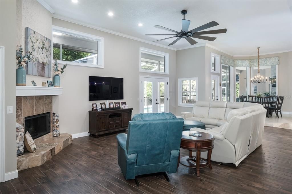 Chandelier, Dining room, Fireplace, Interior, Living room, Recessed Lighting, Wood Texture Flooring